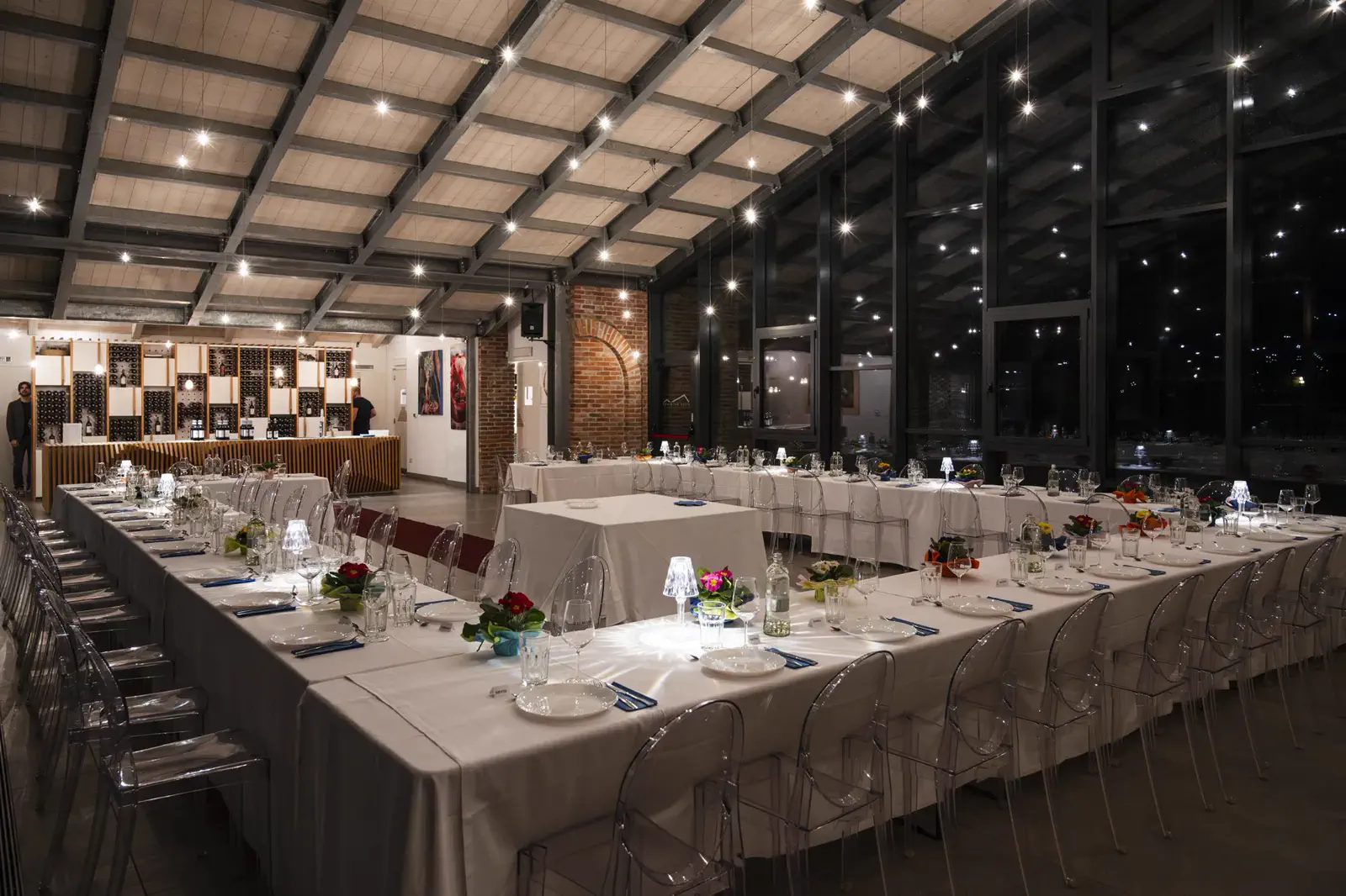 Sala vetrata allestita per una cena a lume di candela