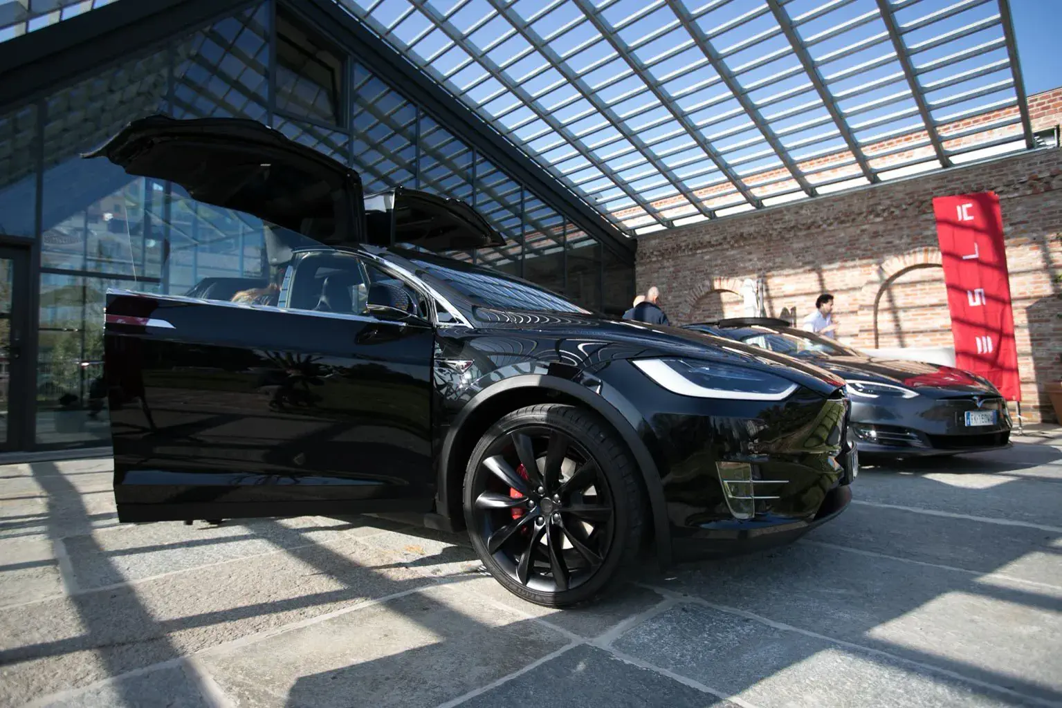 Esposizione di automobili nella sala vetrata durante un evento aziendale